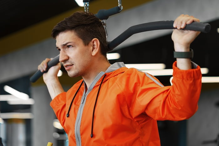 young man working out training back muscles